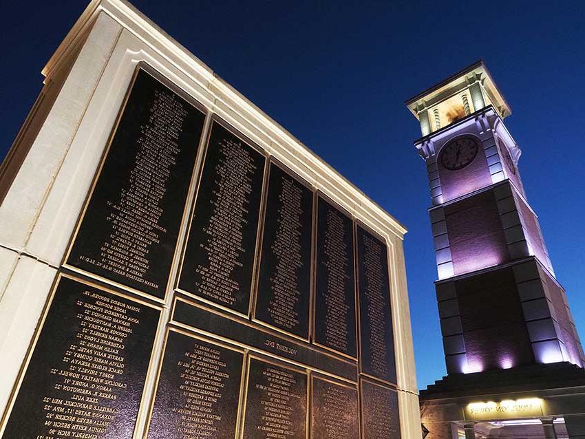 Moulton tower and wall of honor at night.